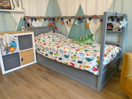 A painted KURA bed becomes the centerpiece of this toddler room