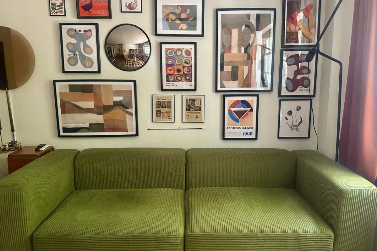 Green IKEA JÄTTEBO sofa in front of an wall gallery