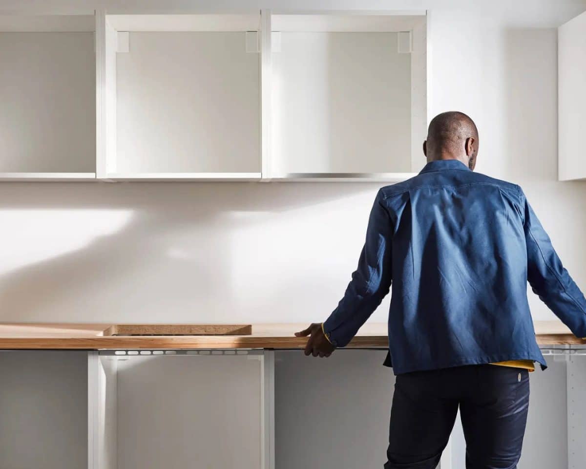 ikea measuring kitchen - IKEA Hackers Man measuring IKEA kitchen countertop