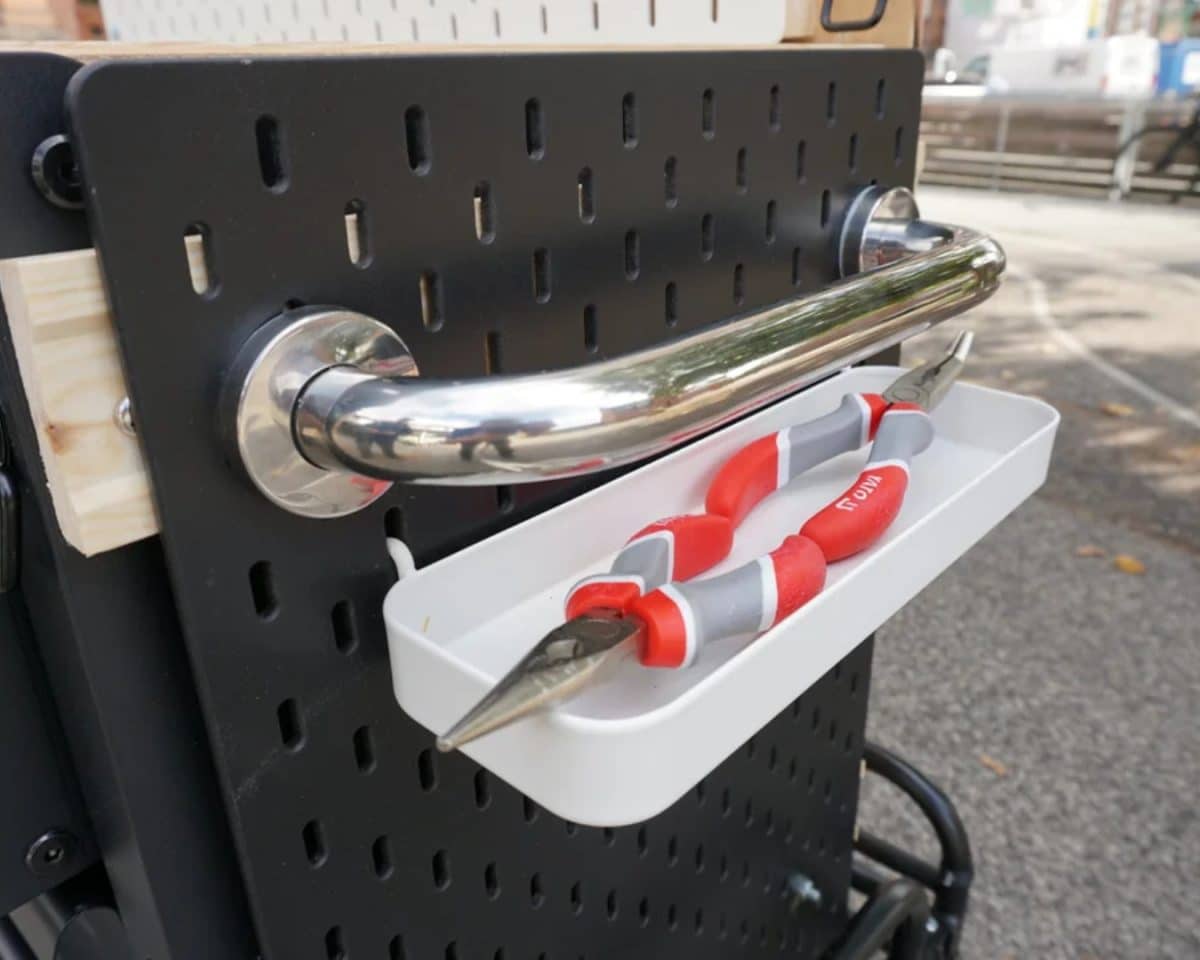 SKÅDIS pegboard attached to BROR cabinet and installed on bike trailer