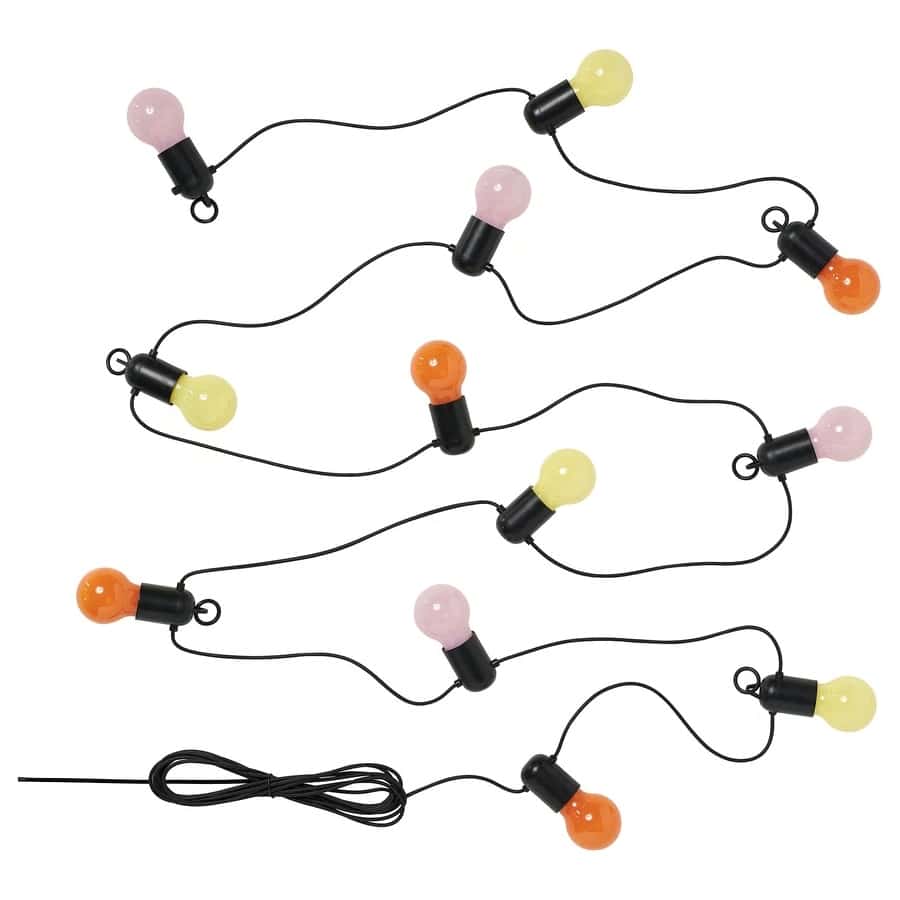 Decorative string lights with pastel pink, yellow, and orange bulbs on a black cord against a white background.