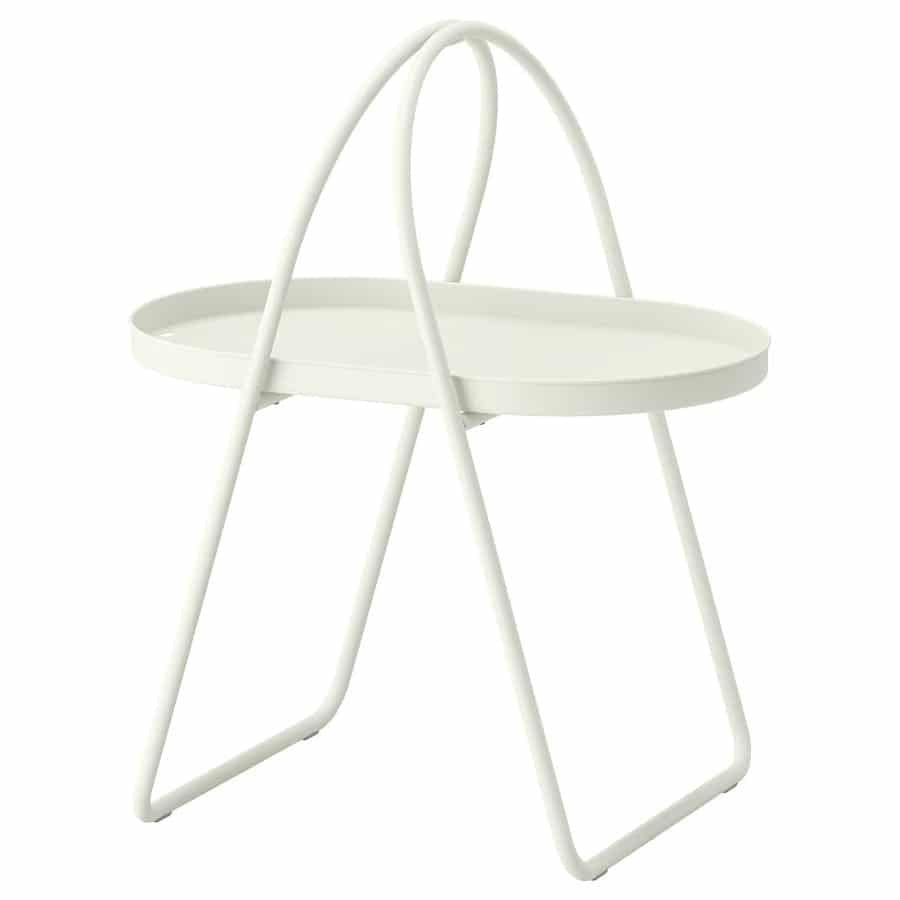 White metal plant stand with a round, shallow tray on top and curved supporting legs.