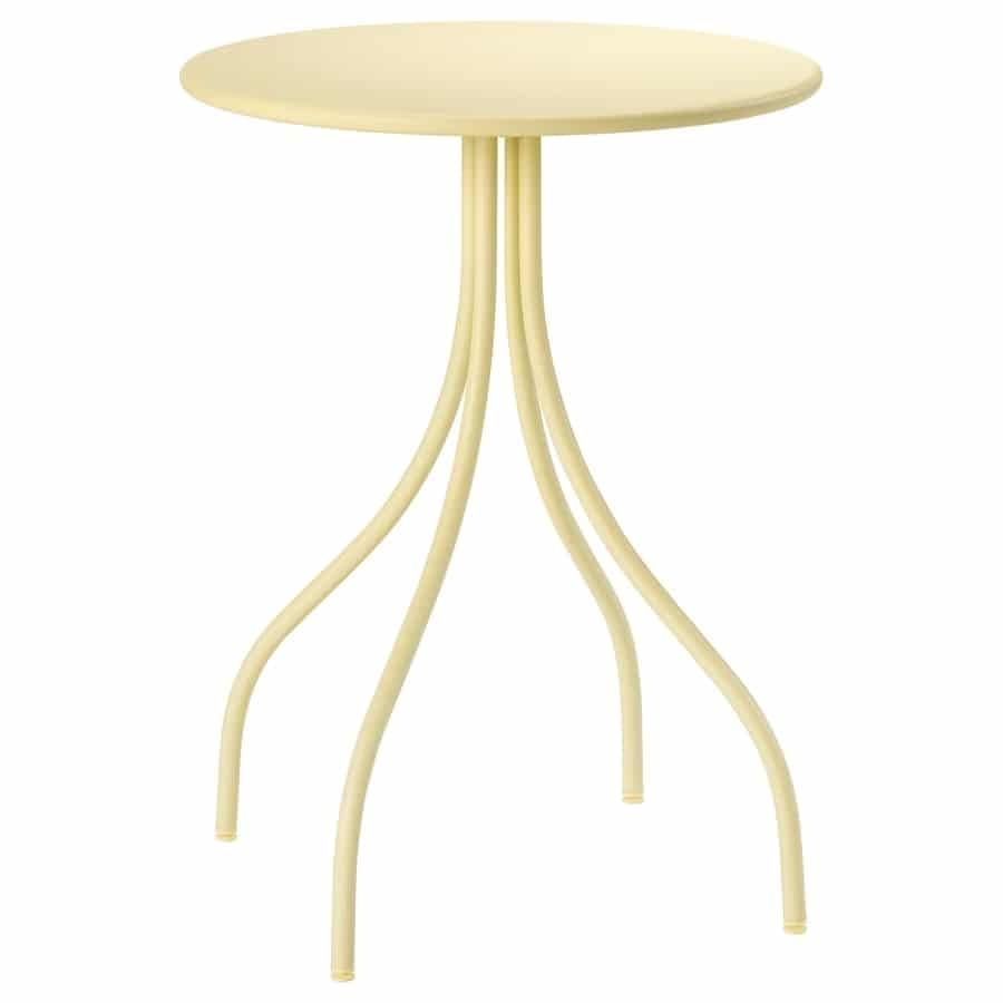 Round, pale yellow side table with a circular tabletop and four sculpted, curved legs.