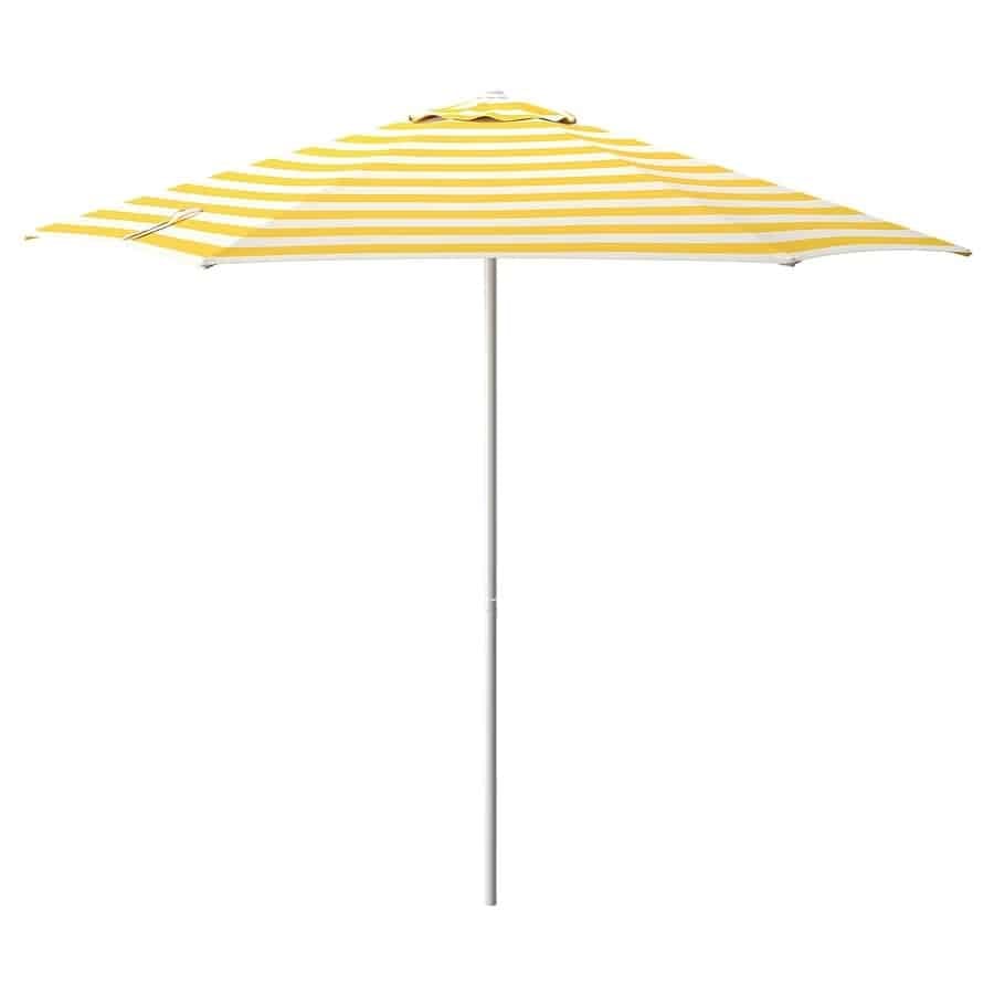 Yellow and white striped patio umbrella opened on a metal pole against a white background