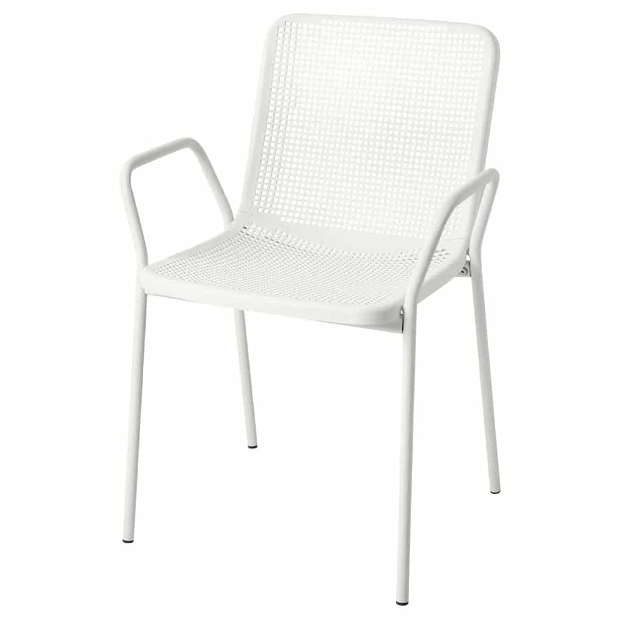 White perforated metal chair with armrests and slim legs, shown at a slight angle