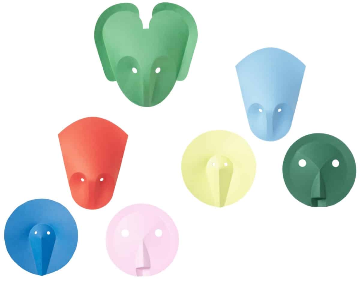 Colorful paper elephant faces arranged in a collage, each with a trunk and two white eyes.