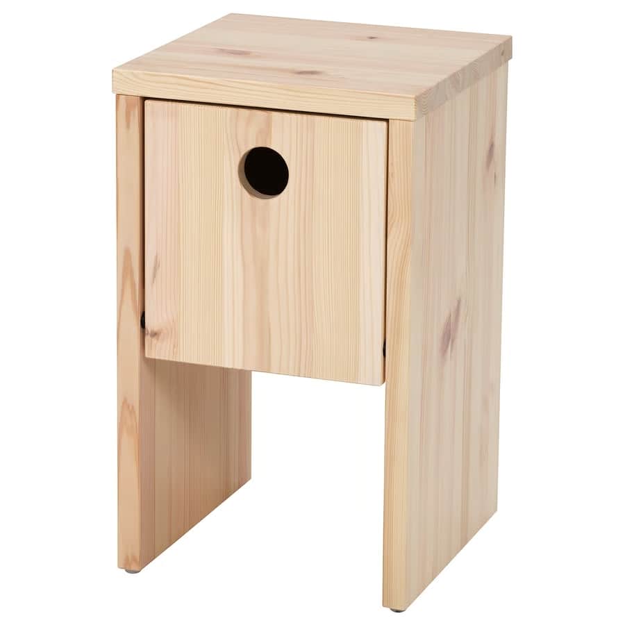 Natural wood nightstand with a single front drawer and a round hole handle, standing on two sturdy legs.