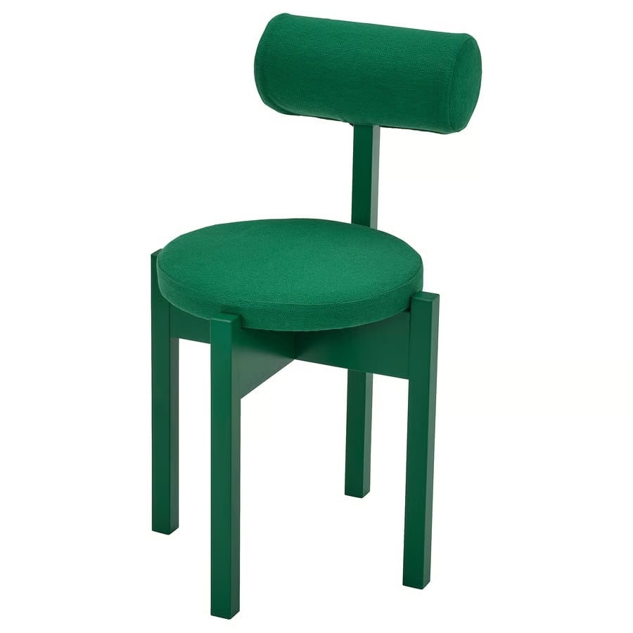 Green upholstered chair with a round cushioned seat, cylindrical backrest, and green-painted wooden legs.