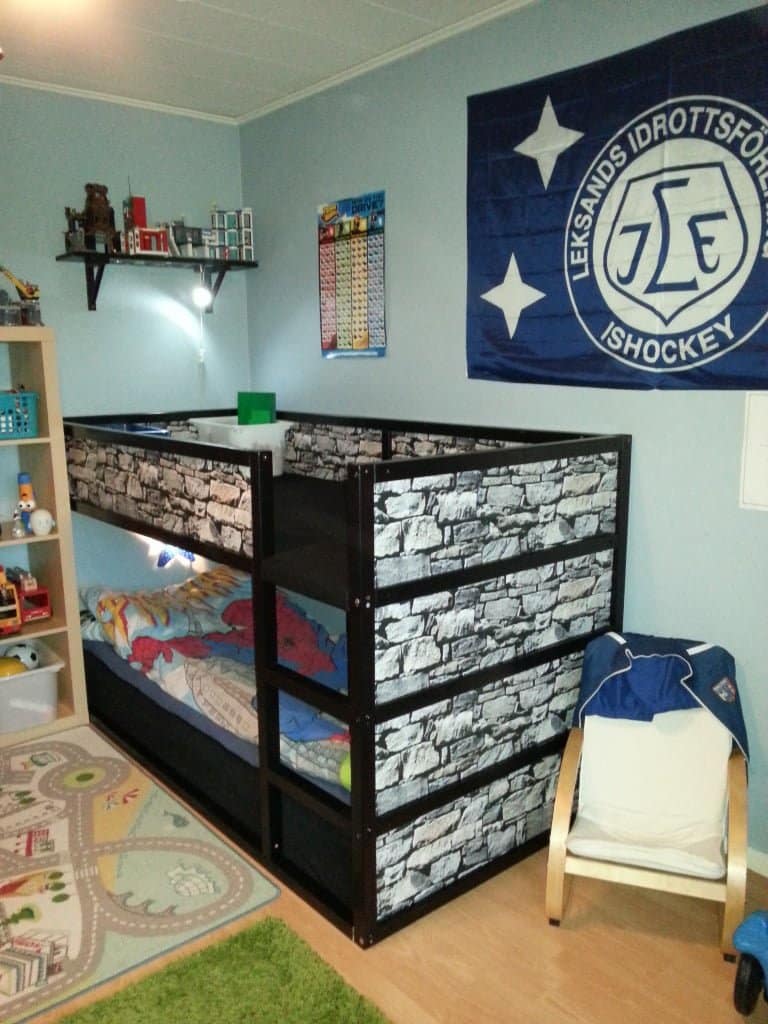 2013-12-22-095701-768x1024 - IKEA Hackers Two-level bunk bed with a black frame and brick-pattern panels in a child's room, with a chair and jacket nearby.
