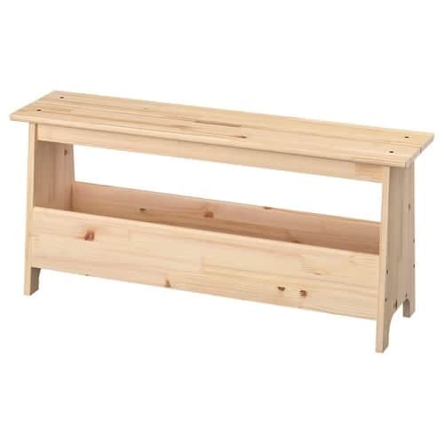 9 - IKEA Hackers Light wood workbench with a long top and a lower open shelf, freestanding with angled legs.