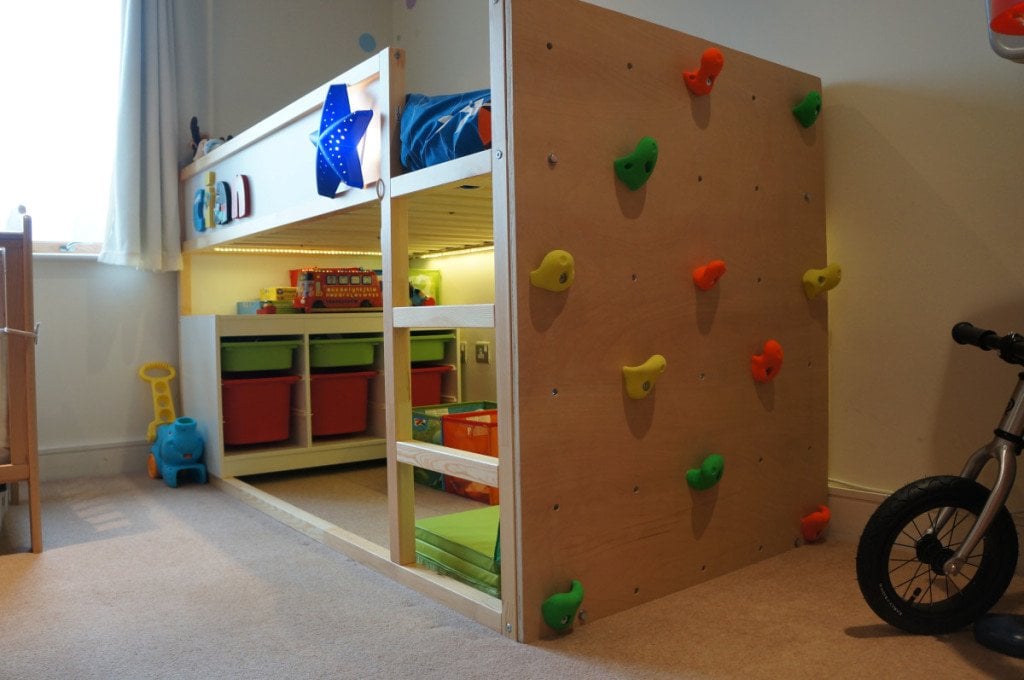 DSC05208-1024x680 - IKEA Hackers Children's bedroom with a loft bed, a colorful climbing wall panel, and toy storage bins beneath it.