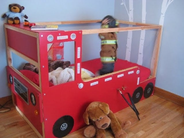 small_2_small_20130221_IMG_0906-730769 - IKEA Hackers Red fire-truck bed in a child's room, with a child climbing on top and stuffed animals nearby.