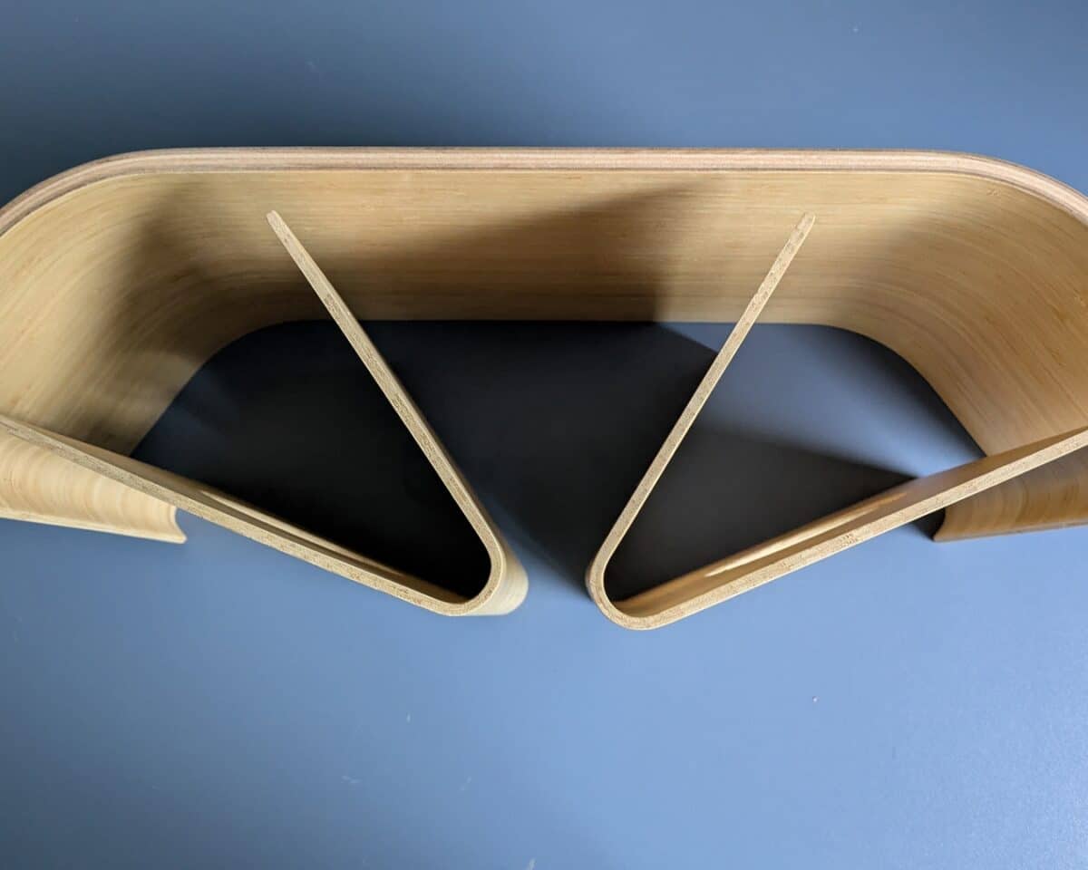 3 - IKEA Hackers Curved bent-plywood sculpture forming two interlocking arches against a blue background.