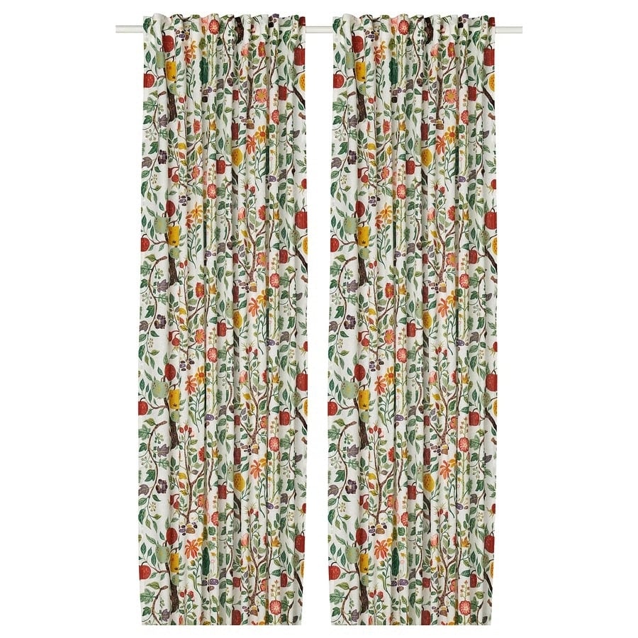 Pair of floral patterned curtain panels in a bright multicolor print on a white background, hanging from a rod.