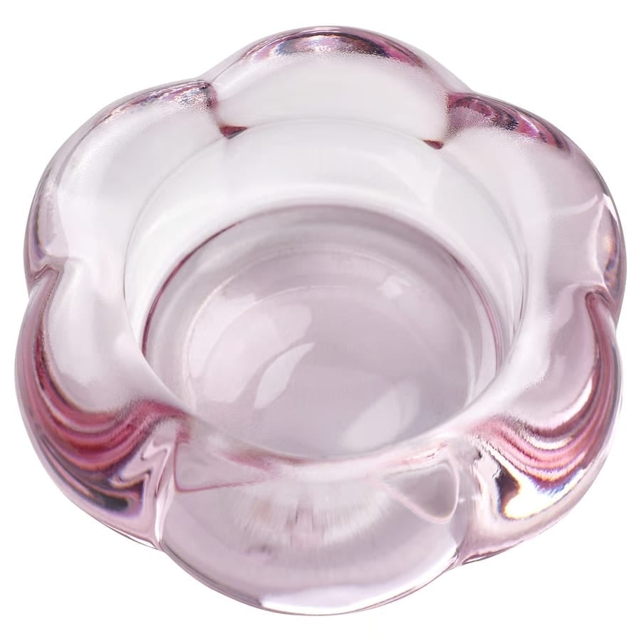 Top-down view of a pink, translucent glass bowl with a scalloped, flower-like rim.