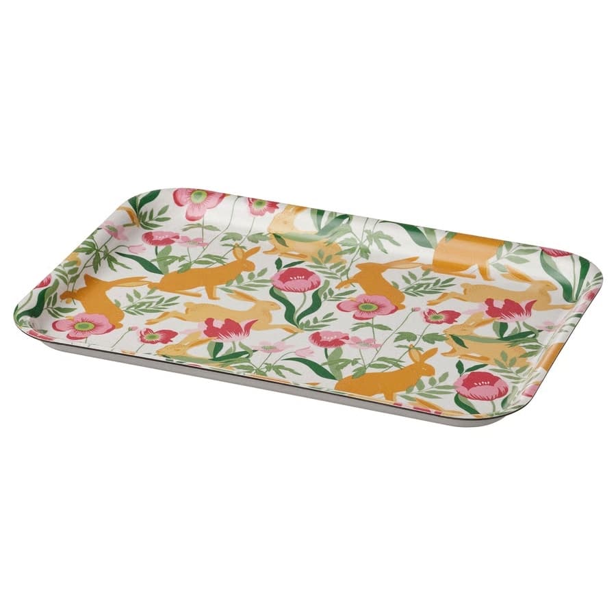 Decorative rectangular serving tray with a white background and a colorful floral and rabbit pattern laid flat at an angle.