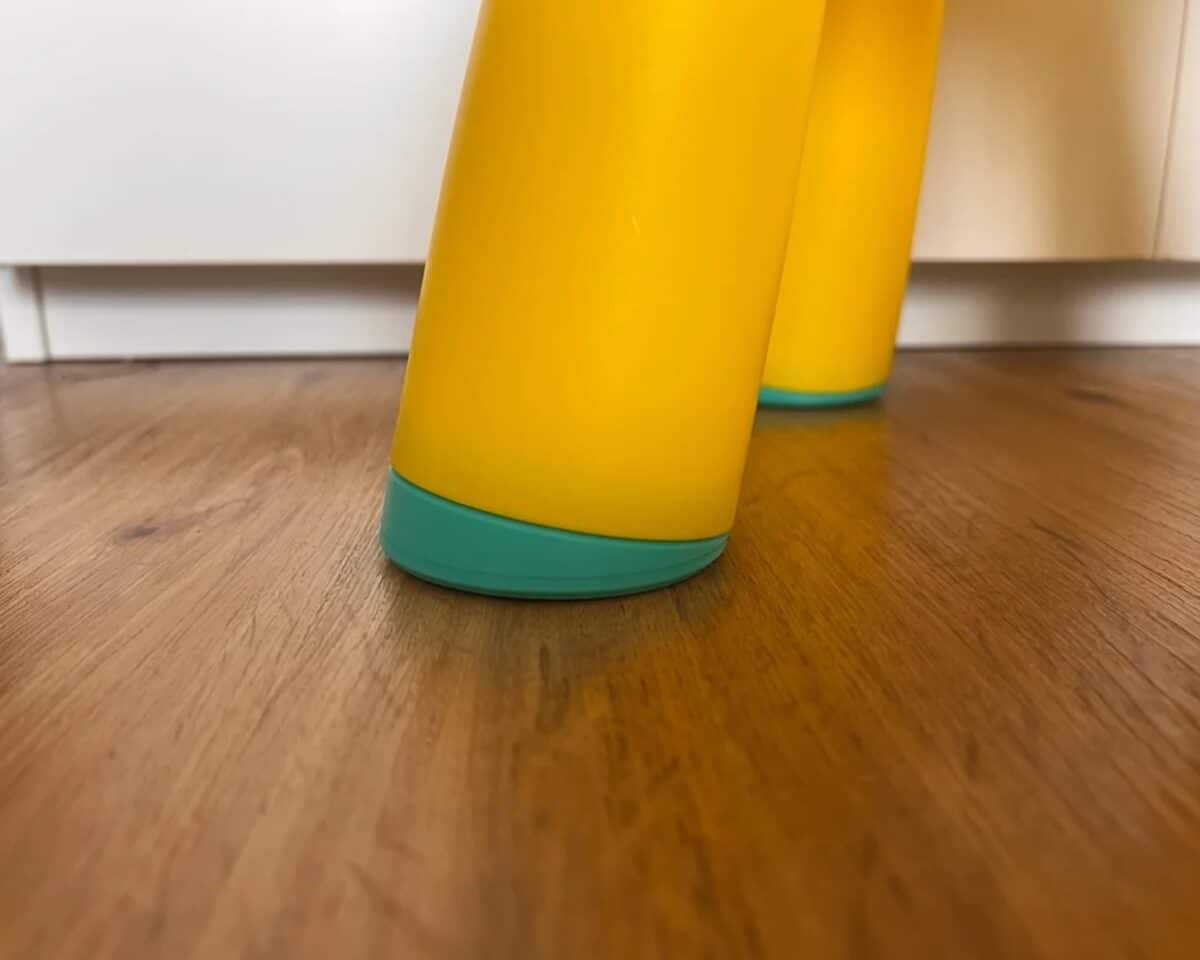 Close-up of IKEA MAMMUT stool feet viewed from ground level.