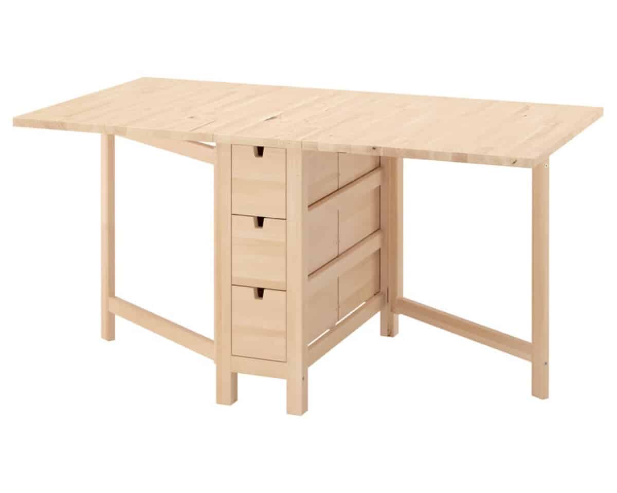 4 - IKEA Hackers NORDEN Gateleg Table - Wooden workbench with a large flat top and central drawer unit for storage, supported by four legs.