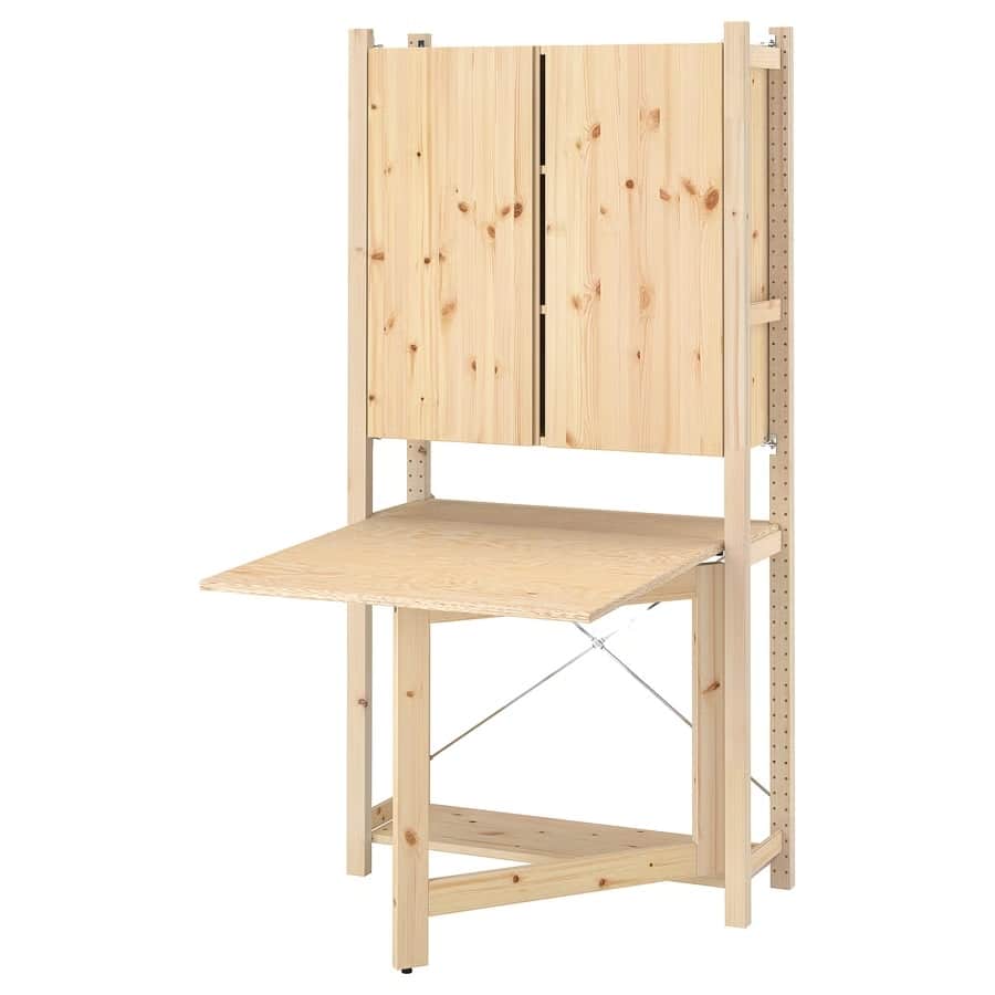 5 - IKEA Hackers IVAR Fold-Down Desk - Wooden workshop workbench with a fold-down desk surface and a two-door cabinet above, mounted on side posts.