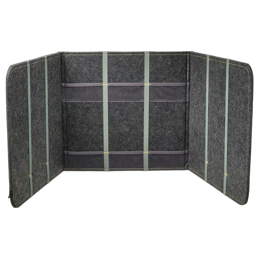 7 - IKEA Hackers ÖVNING Portable Desk Divider - Open charcoal felt desk divider with three vertical elastic straps and two rows of mesh pockets inside.