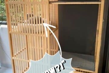 Tall wooden cabinet with vertical slats, left side, and dark back panel visible on the right.