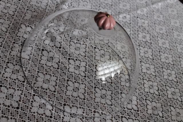 IMG_4971-749144 - IKEA Hackers Clear round glass plate with a small pink pumpkin on its rim, placed on a delicate lace tablecloth.