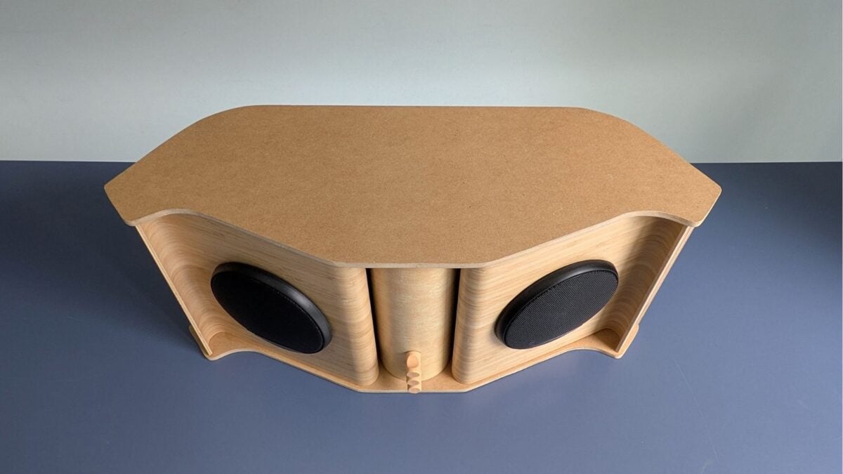 ikea bamboo speakers top view - IKEA Hackers Curved wooden speaker enclosure with two round black drivers and a central vertical panel on a blue tabletop