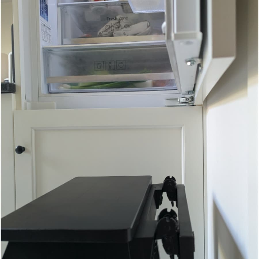 28 - IKEA Hackers Open refrigerator freezer with two sliding drawers labeled Fresh Zone; a black pull-out rack is in the foreground.