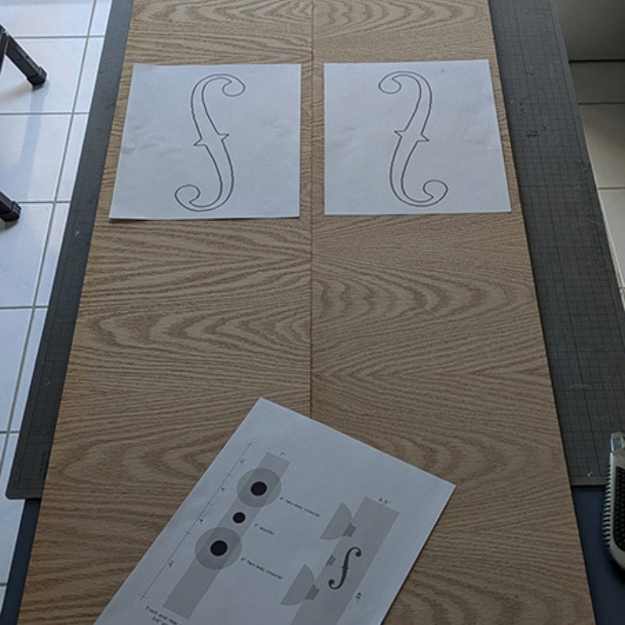40 - IKEA Hackers Two white sheets on a wooden table each showing a large decorative curly brace-like shape, likely templates for tracing.