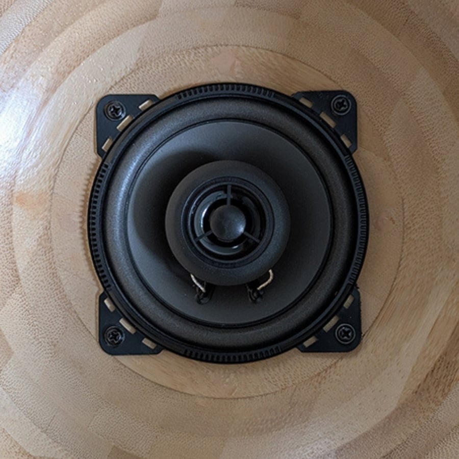 54 - IKEA Hackers Close-up of a round black speaker driver mounted in a wooden circular enclosure.