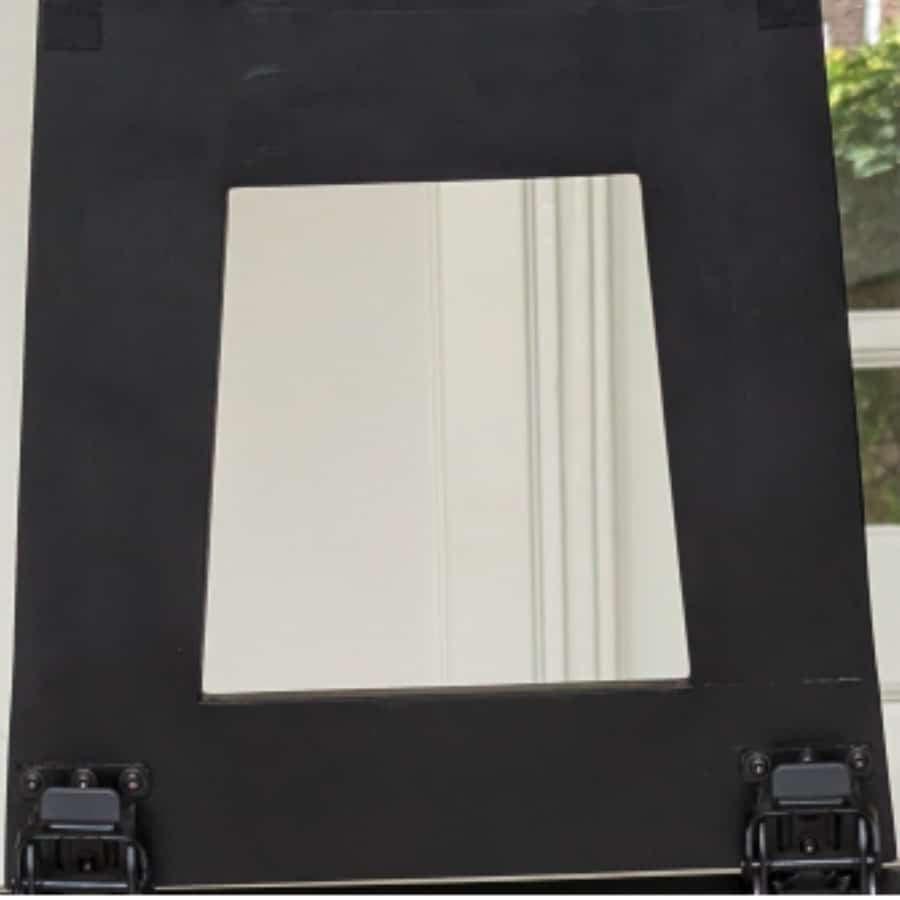 IKEA Blog pics 1 - IKEA Hackers Black wooden frame with a square central opening; hinges at the bottom, white wall visible behind the opening.