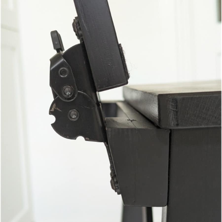 IKEA Blog pics 2 - IKEA Hackers Close-up of a black metal hinge and support bracket attached to a dark wooden table leg/section of furniture.