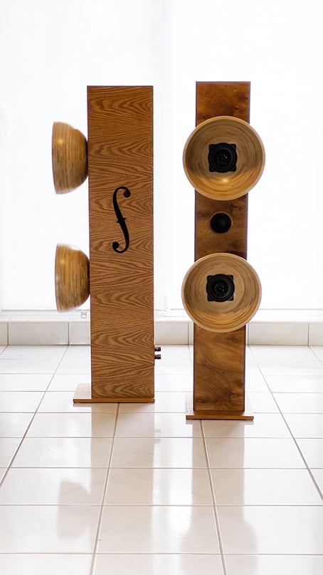 blanda bowl speakers 7 - IKEA Hackers Two tall wooden columns with large round bowls attached to the sides, forming an artistic speaker-like sculpture in a bright room.