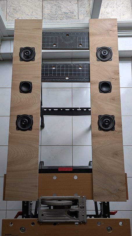 speaker assembly - IKEA Hackers Tall wooden speaker cabinet with six circular drivers (three per side) surrounding an open central compartment.